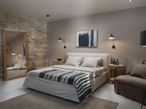 a bedroom with a bed and a couch and a mirror at Villa Melon by Interhome in Poreč