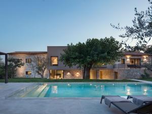 a house with a swimming pool in front of a house at Villa Melon by Interhome in Poreč