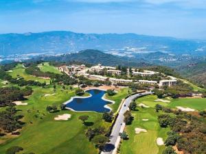 an aerial view of a golf course with a lake at Apartment Hapimag-2 by Interhome in Platja  d'Aro