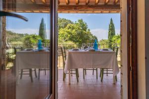a dining room with two tables and a glass door at Apartments La Tenuta where the sea meets the land - Goelba in Porto Azzurro