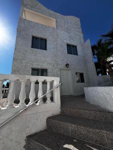 a white building with a staircase in front of it at Whale Hill in Puerto Peñasco