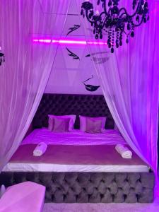 a pink room with a bed with a pink ceiling at Mystik Penthouse in Sighişoara