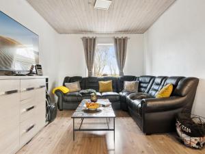 Holiday Home Elara - 300m from the sea in The Liim Fiord by Interhome في Thyholm: غرفة معيشة مع أريكة جلدية وطاولة