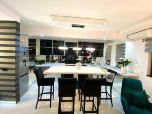 a kitchen and dining room with a table and chairs at Mystik Penthouse in Sighişoara +19 photos