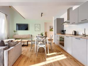 a kitchen and living room with a couch and a table at Studio Zanet by Interhome in Fažana +21 photos