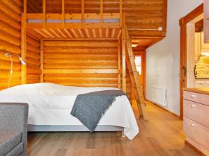 a bedroom with a bunk bed and a ladder at Holiday Home Rustholli 9 by Interhome in Tampere