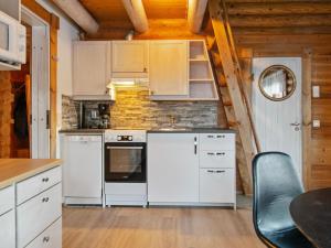 a kitchen with white appliances and a wooden ceiling at Holiday Home Rustholli 9 by Interhome in Tampere +14 photos