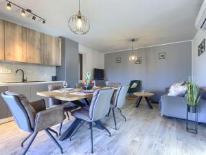 a kitchen and a dining room with a table and chairs at Apartment Emili by Interhome in Vižinada +25 photos