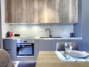 a kitchen with a table and a sink and a sink at Apartment Emili by Interhome in Vižinada