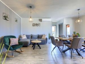 a living room with a couch and a table and chairs at Apartment Emili by Interhome in Vižinada