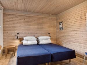 a bedroom with a bed in a wooden wall at Holiday Home Selenia - 1km from the sea in NW Jutland by Interhome in Saltum