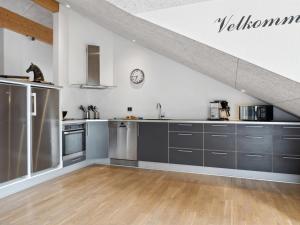 a kitchen with stainless steel appliances in a loft at Holiday Home Ernstine - 1km from the sea in NW Jutland by Interhome in Hanstholm