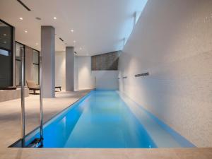 a swimming pool in the middle of a house at Qgat Restaurant Events & Hotel in Sant Cugat del Vallès