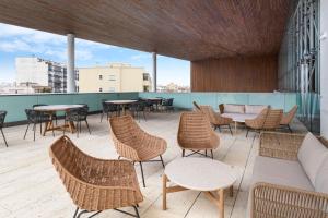 un patio con mesas y sillas en un edificio en B&B HOTEL Olhão Algarve, en Olhão