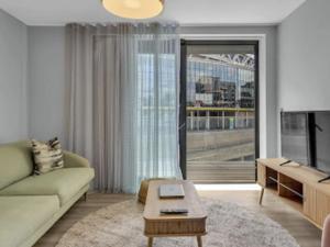 a living room with a couch and a tv at Apartment Wembley Park apartments-2 by Interhome in London