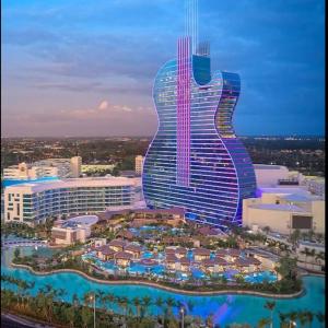 a large guitar shaped building with a resort at King Bed, 3 miles to Stadium in Miami Gardens