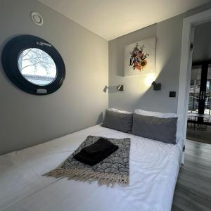 a bedroom with a large white bed with a window at La Mare Resort in Gothenburg