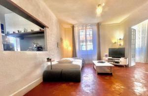 a living room with a couch and a tv at AA OT Maison du Moulin - Old Town - Promenade des in Nice