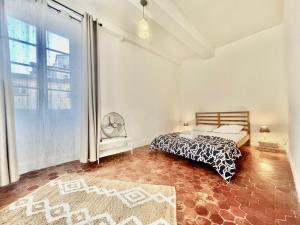 a bedroom with a bed and a large window at AA OT Maison du Moulin - Old Town - Promenade des in Nice
