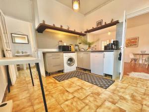 a kitchen with a washer and dryer in a room at AA OT Maison du Moulin - Old Town - Promenade des in Nice