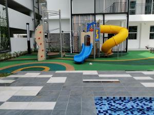a playground with a slide in a building at BAYU HOME in Seremban