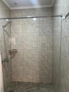 a bathroom with a shower with a glass door at Отель Рублёвка in Kant