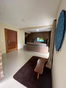 a large bedroom with a bed and a rug at Casa para temporada em Alto Caparaó MG in Caparaó Velho