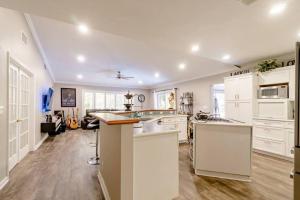 a kitchen with white cabinets and a counter top at Life's a Beach in Lake Worth