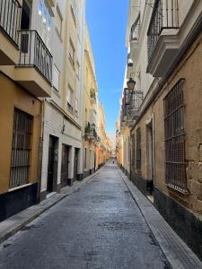 une rue vide dans une ruelle entre bâtiments dans l'établissement Rinconcito del Falla Grupo AC Gestion, à Cadix