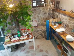 a table with plates of food on it next to a tree at Adriatrek Bed & Breakfast in Petrovac na Moru