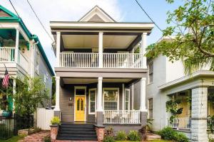 a large white house with a yellow door at Historic 3 Bedroom Home in Jacksonville