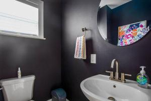 a bathroom with a sink and a mirror at Historic 3 Bedroom Home in Jacksonville