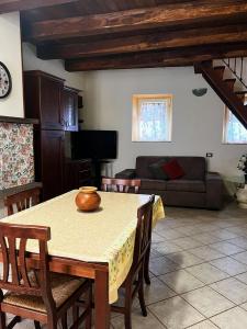 a living room with a table and a couch at La Loggetta in Valentano