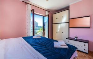 a bedroom with a large bed and a large window at Apartment Serda in Ugljan