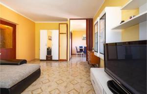 a hotel room with a flat screen tv and a bed at Apartment Serda in Ugljan