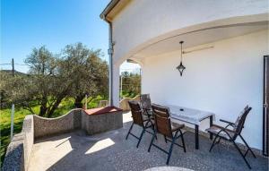 a patio with a table and chairs and a view at Apartment Serda in Ugljan