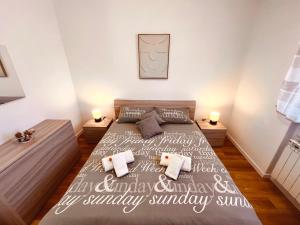 a bedroom with a large bed with two night stands at IL DANDY appartamento con parcheggio in Trieste +16 photos
