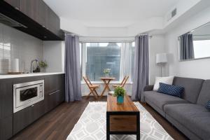a living room with a couch and a table at Downtown Apartments 10 in Toronto
