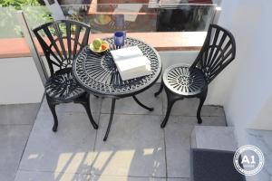 a table and chairs with a plate of food on it at Oporto House Garden in Porto