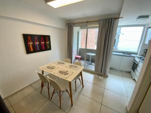 a small dining room with a table and chairs at 9 de Julio 930 5 B in Rosario