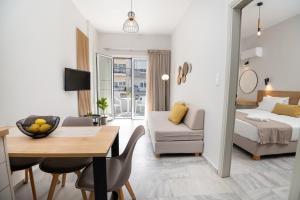 a living room with a bed and a dining room at Mardinik Hotel Apartments in Rethymno