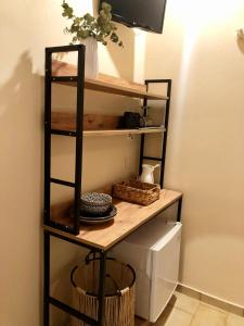a wooden shelf in a room with a table at Marina rooms in Argostoli