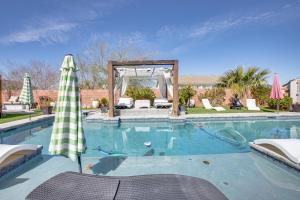 ein großer Pool mit Sonnenschirm und Anophe in der Unterkunft Luxurious Henderson Retreat - 13 Mi to The Strip! in Las Vegas