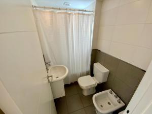 a small bathroom with a toilet and a sink at 9 de Julio 930 5 B in Rosario