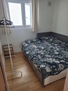 a bedroom with a bed and a window at 2 double bedrooms apartment near airport & town in Dublin