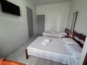 Postel nebo postele na pokoji v ubytování Carlton Express Imbiara