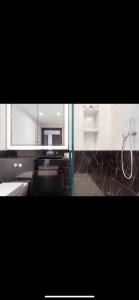 een badkamer met een douche, een wastafel en een spiegel bij Exclusive Large Parliament Apartment in Londen