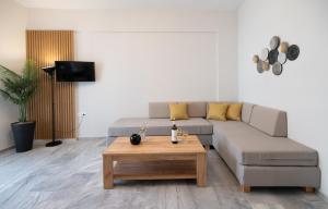 a living room with a couch and a coffee table at Mardinik Hotel Apartments in Rethymno
