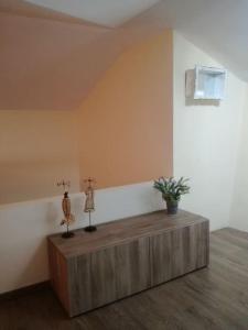 a room with two figurines on top of a wooden table at On the Rocks Myrto in Afissos +16 photos