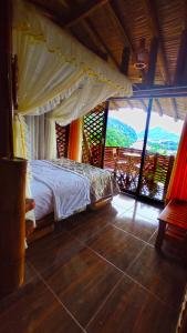a bedroom with a bed in a room with a view at La Bella y El Leon in Tingo María